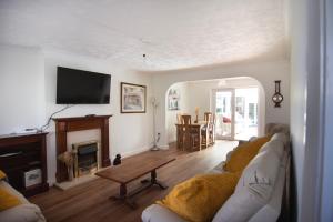 a living room with a couch and a fireplace at Bilbo's Cottage, Sheringham in Sheringham