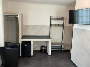 a room with a desk and a chair and a table at Etna Hotel & Ristorante in Veitshöchheim