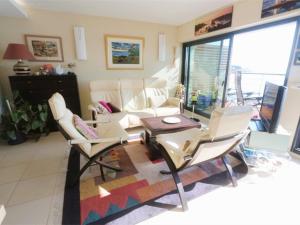 a living room with a couch and a table and chairs at Bénodet, appart. 3*, plage à pied, parking privé - FR-1-481-52 in Bénodet