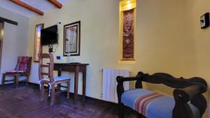 a bedroom with a desk and a bed and a desk at La Posada del Rio in Tilcara