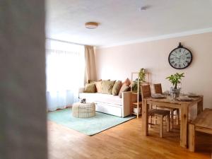 a living room with a white couch and a table at BohèmeNest Terminal Apartments - Chic & gemütlich mit Terrasse in Waldenbuch +16 photos