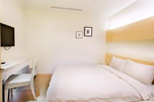 Voodi või voodid majutusasutuse Wemeet Hotel Taipei toas