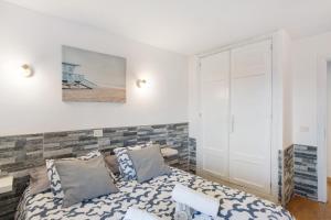 a bedroom with a bed and a mirror at Sunset Apartment in Puerto Rico de Gran Canaria +27 photos