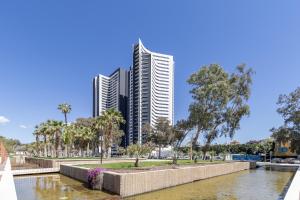 two tall buildings in a city with a river at Malaga Skyline 4 Pool & Parking Free in Málaga