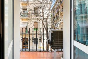 a window view of a building with a black gate at Lodging Apartments Beach Studio P1 in Barcelona