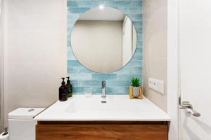 a bathroom with a sink and a mirror at Lodging Apartments Beach Studio P1 in Barcelona