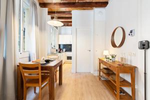 a kitchen and dining room with a wooden table and chairs at Lodging Apartments Beach Studio P1 in Barcelona +10 photos