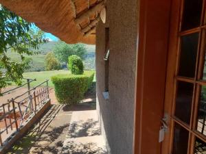 a door to a building with a view of a yard at Ribaneng Lodge in Ribaneng