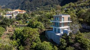an aerial view of a house on a mountain at Mar Yam Sea by Atlantic Holiday in Arco de São Jorge