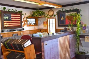 a bar with an american flag on the wall at Purple Sage Motel in Snyder
