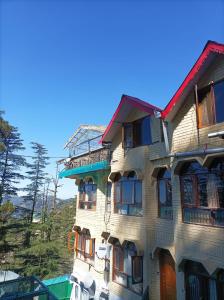 a tall building with many windows on the side of it at Hotel Rajat in Shimla