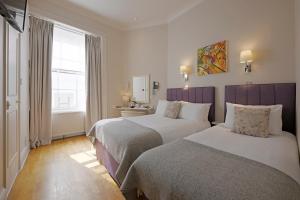 Postel nebo postele na pokoji v ubytování Harlingford Hotel