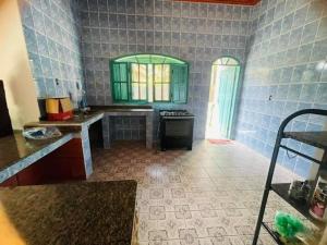 a kitchen with a sink and a stove in a room at Pousada e Hostel Vida no Paraiso in Angra dos Reis