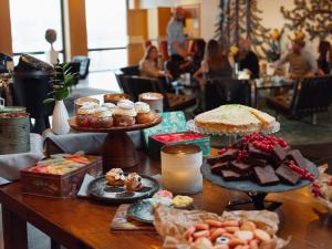 a table topped with different types of cakes and pastries at Rönneberga Konferens in Lidingö