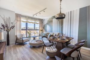 a living room with a table and chairs at Malaga Skyline 4 Pool & Parking Free in Málaga