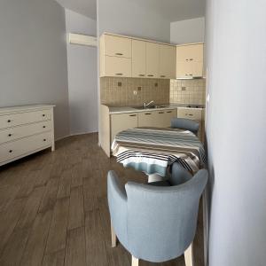 a small room with a bed and a chair at Turquoise Beachside Apartments in Dobrota