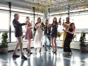 a group of people standing on a dance floor drinking champagne at Rönneberga Konferens in Lidingö