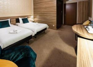 Łóżko lub łóżka w pokoju w obiekcie Hotel Iskierka Business & Spa