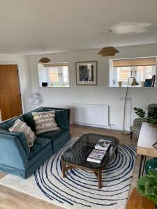 a living room with a couch and a coffee table at Pretty cottage near Cirencester in Purton