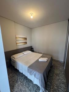 a bedroom with a large bed with two towels on it at Locking's Lourdes 3 in Belo Horizonte