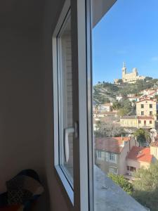 a window with a view of a city at Appartement Unique - Roucas Blanc in Marseille
