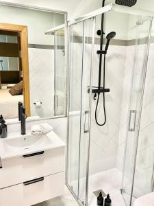 a bathroom with a shower and a sink at Estudio Regenta Con Parking privado in Oviedo