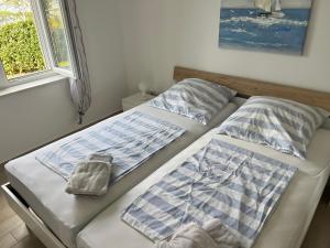 two beds sitting next to each other in a bedroom at Villa Rudy Holiday Home in Njivice