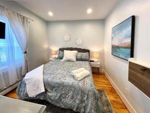a bedroom with a bed and a large window at Renovated 4bed 15 Bath, Mit, Harvard,hospitals in Cambridge