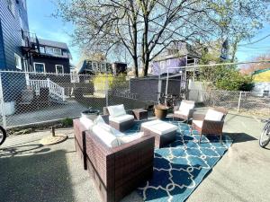 a patio with chairs and tables and a fence at Renovated 4bed 15 Bath, Mit, Harvard,hospitals in Cambridge