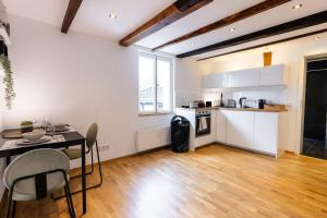 a kitchen and dining room with a table and chairs at Fachwerk Boutique-Hotel 1 in Hattingen