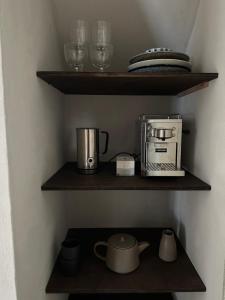 a kitchen shelf with a coffee maker and a toaster at Nordic Design Residency / Natural habitat in Copenhagen