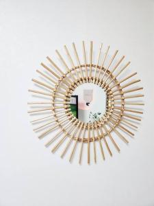 a gold circular mirror on a white wall at Home Woodsage in Seoul