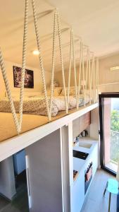 a room with a counter with ropes hanging from the ceiling at Tivat lovely cosy studio in Tivat