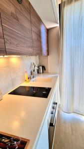 a kitchen with a sink and a counter top at Tivat lovely cosy studio in Tivat