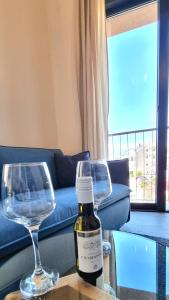 uma garrafa de vinho e dois copos de vinho numa mesa em Tivat lovely cosy studio em Tivat