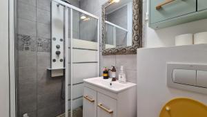 a bathroom with a sink and a mirror at Town Square Apartment in Braşov +17 photos