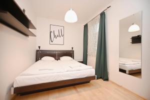 una camera con letto e finestra con tende verdi di Victus Apartamenty, Apartament Chill a Sopot