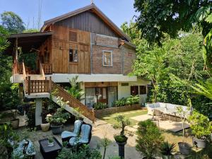 a wooden house with a patio in front of it at Jepara Garden Resort in Jepara