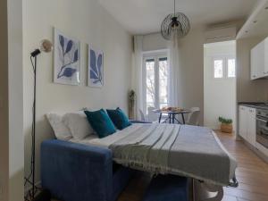 a bedroom with a bed with blue pillows at The Best Rent - Morosini Apartment in Milan