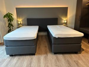 two beds in a room with two bedsitures at Apartment Hideaway in Bad Oeynhausen