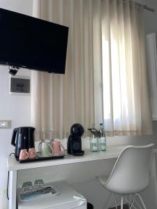 a kitchen counter with a table with a window at B&B SoleLuna in Lampedusa