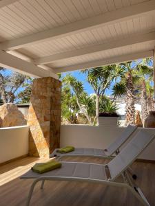 a room with a bed on a patio with palm trees at B&B SoleLuna in Lampedusa