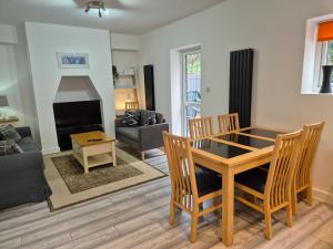 a dining room and living room with a table and chairs at Cromwell Apartment by Cliftonvalley Apartments in Bristol