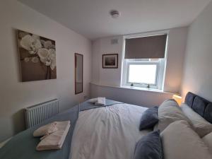 a bedroom with a bed and a window at Cromwell Apartment by Cliftonvalley Apartments in Bristol