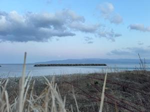 an island in the middle of a body of water at 【佐渡/一棟貸切】オーシャンビュー古民家SeaSideStory椿 離れ in Sado