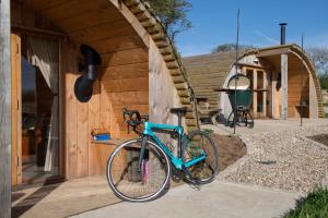 a bike parked in front of a wooden house at Glamping Pod 1 Comfort in Scarborough