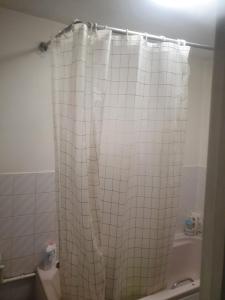 a white tiled shower curtain in a bathroom at Queensgate centre in Stifford