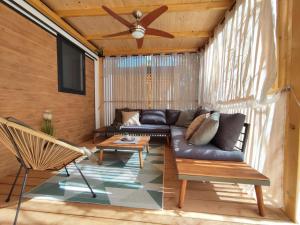 a living room with a couch and a ceiling fan at Mobile home Kala in Biograd na Moru