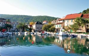 a group of boats in the water in a town at Cozy Home In Donje Selo With Kitchen in Donje Selo na Šolti