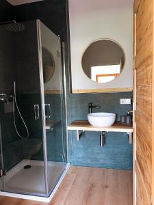 a bathroom with a glass shower and a sink at Nomad Nest in Michelbach an der Bilz